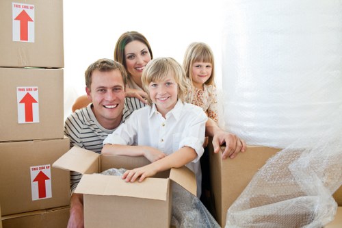 Professional movers handling furniture during a Belsizepark home move